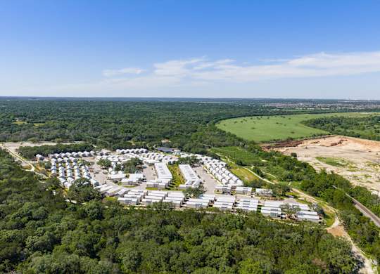 A bird's eye view of a residential area surrounded by greenery.