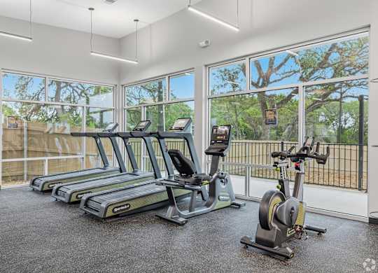 A gym with treadmills and exercise bikes.