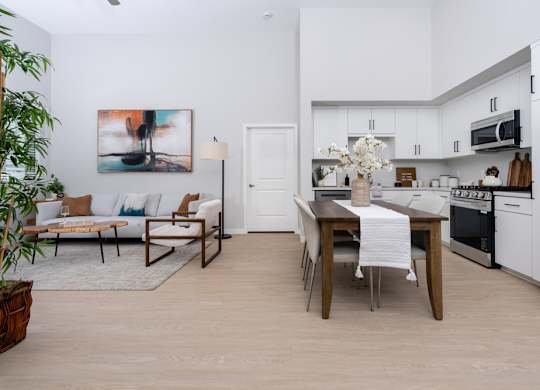 A modern kitchen with a dining table and chairs.