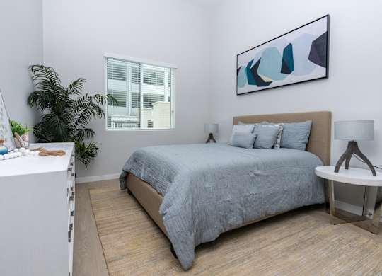 bedroom with window and painting