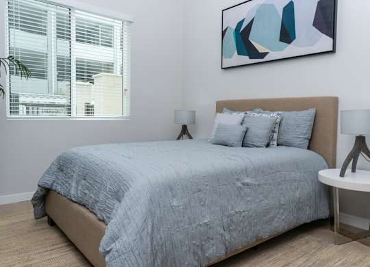 Bedroom with bed, window and painting