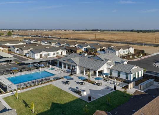 A large building complex with a pool in the middle.