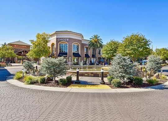 A Chick-fil-A restaurant is surrounded by palm trees and other greenery.