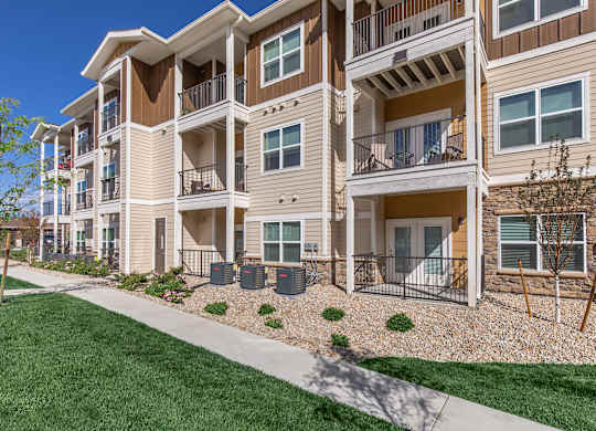 Apartment building with a green lawn in front.