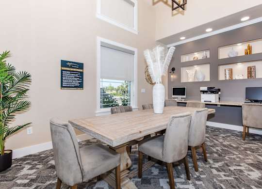 A dining room with a wooden table and chairs.