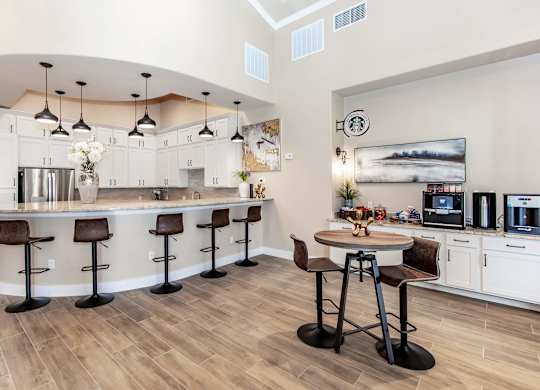 A kitchen with a bar area and a dining table.