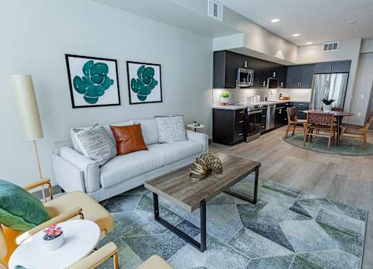 Living Room With Sofa, Coffee Table, Area Rug, Chairs And Floor Lamp. at Bayswater Apartments, Burlingame