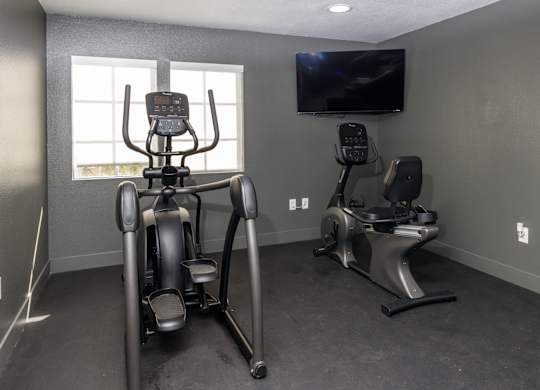 A home gym with a stationary bike and a treadmill at Verandas Apartments, West Covina