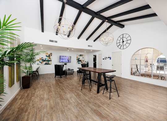 A room with wooden floors and a large mirror on the wall.
