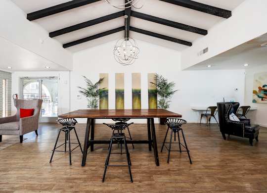 A dining room with a wooden table and chairs.