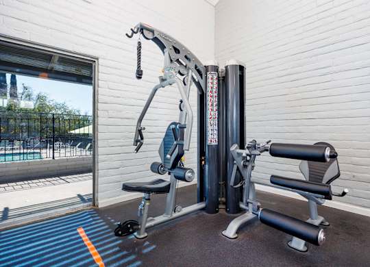 A gym machine is in front of a window.