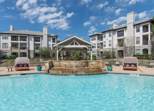 Large swimming pool with a waterfall at Silverado, Frisco, Texas
