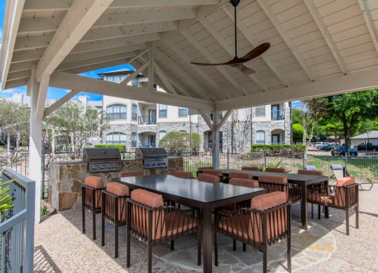 Covered patio with tables and chairs and a grill at Silverado, Frisco, TX, Texas, 75034