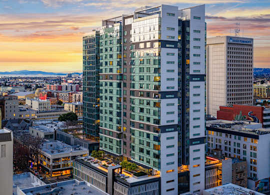 A cityscape with buildings and a sunset.
