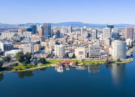 A cityscape with a large body of water in the foreground.