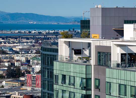 A modern building with glass windows is seen from a distance.