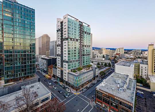 A cityscape with modern buildings and a clear sky.