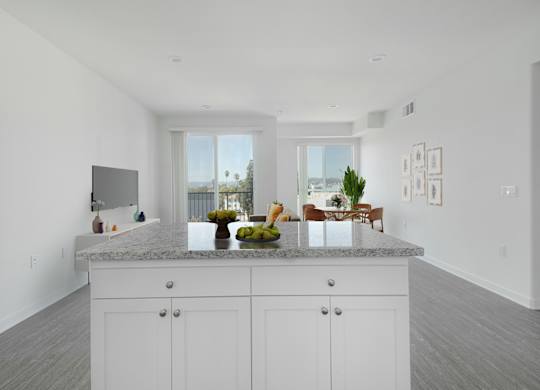 A kitchen with white cabinets and a marble countertop.at 422 South Lake, Los Angeles  