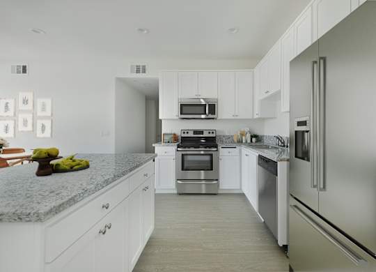 A modern kitchen with stainless steel appliances and white cabinets.at 422 South Lake, Los Angeles, CA  