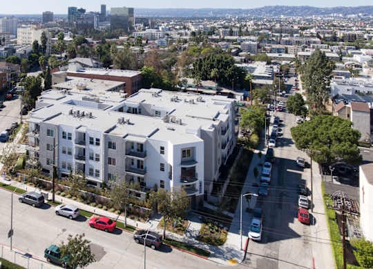 A large white building with a parking lot in front of it.at Grand View Towers, Los Angeles, CA 90057  