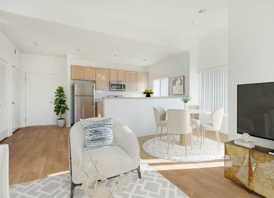 A modern living room with a white sofa and a television.at Grand View Towers, Los Angeles, 90057  