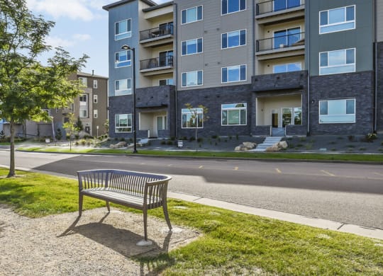 a park bench sitting on the side of a street at Parkside at Littleton Village, Littleton