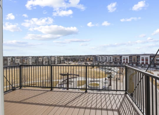 a balcony with a view of a playground and a city at Parkside at Littleton Village, Colorado