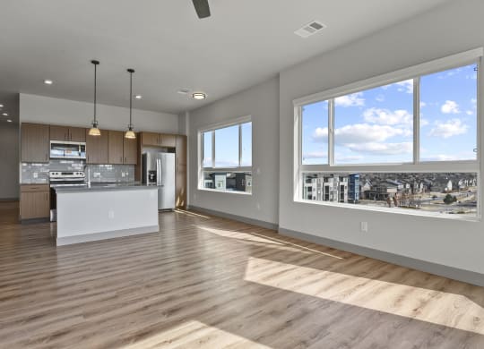 an open kitchen and living room with a view of the city at Parkside at Littleton Village, Colorado, 80122