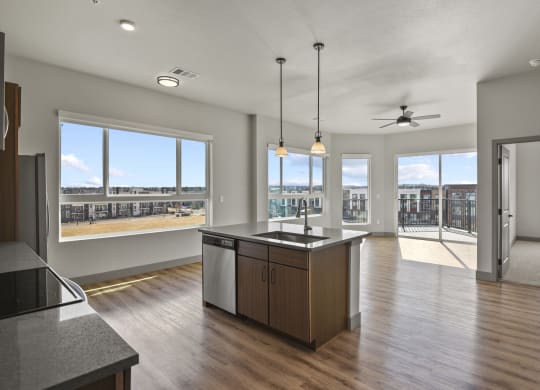 an open kitchen and living room with a view of the city at Parkside at Littleton Village, Colorado, 80122