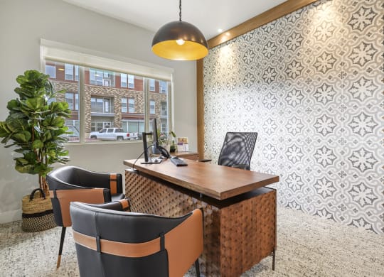 a conference room with a wooden table and chairs and a large window at Parkside at Littleton Village, Littleton, CO