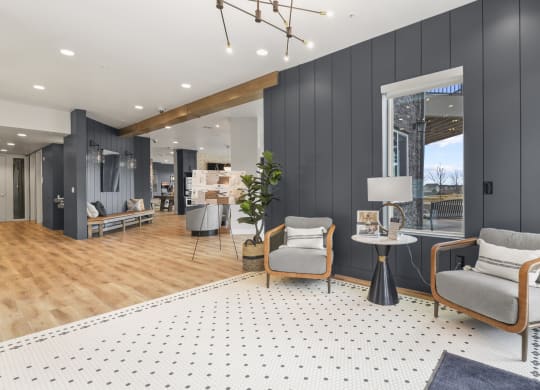 a living room with two chairs and a rug at Parkside at Littleton Village, Littleton, Colorado