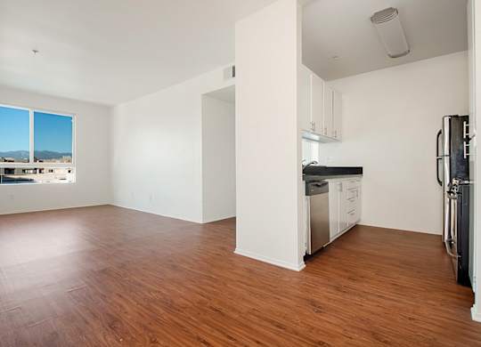 Empty room with wooden floors and white walls.at Plaza Lafayette, Los Angeles, CA 90057  