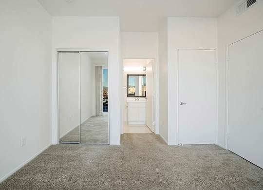 A hallway with a carpeted floor and white walls.at Plaza Lafayette, California  