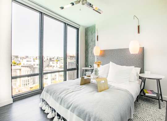 A bedroom with a large bed and a view of the city.at The Rise, California  