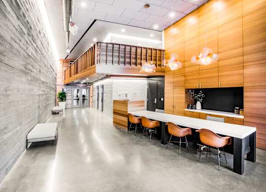 A long white table with chairs is in the middle of a room.at The Rise, California, 94103