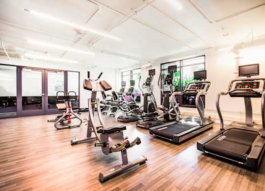 A gym with treadmills, exercise bikes, and other equipment.at The Rise, San Francisco California  