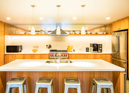 A kitchen with a white counter top and stainless steel appliances.at The Rise, San Francisco  