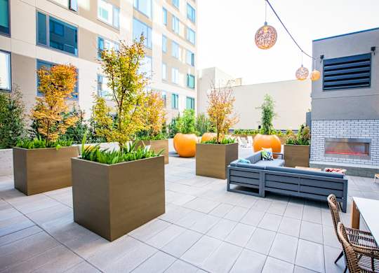 A patio with a fireplace and chairs.at The Rise, San Francisco California  