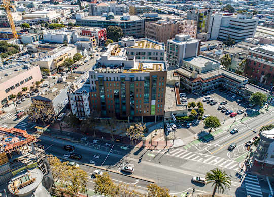 A city street with cars and buildings.at The Rise, San Francisco, CA  