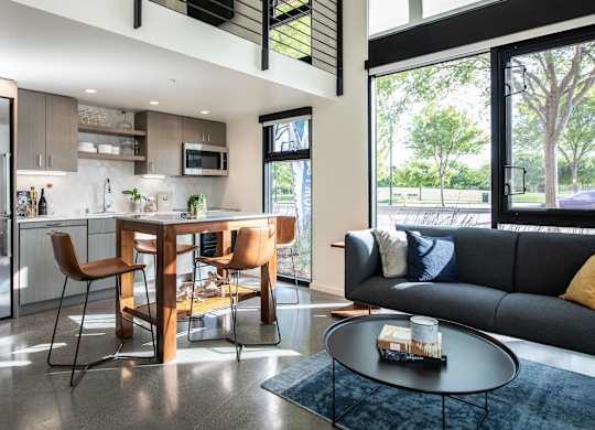 A modern kitchen with a dining table and chairs.