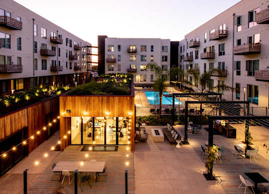A courtyard with a pool surrounded by apartment buildings.