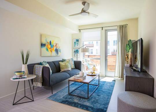 Living room with large doors and ceiling fan