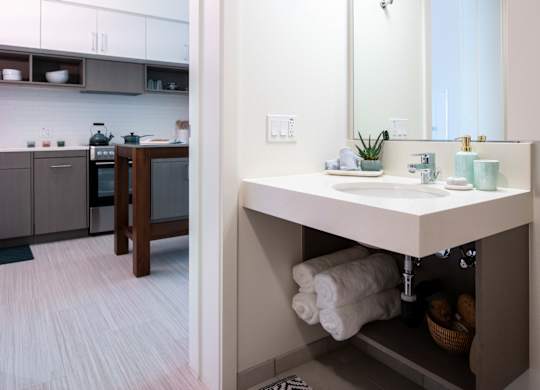 A bathroom with a sink and mirror.