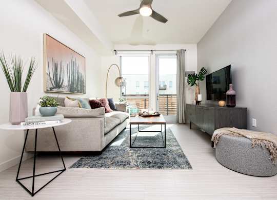 Living room with large doors and ceiling fan