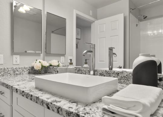 a bathroom with a sink and a mirror at Vaseo Apartments, Arizona