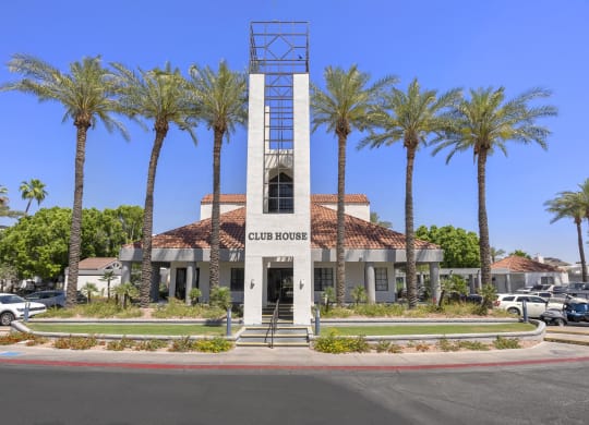 a building with a clock tower in front of palm trees at Vaseo Apartments, Phoenix, AZ 85022