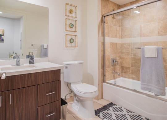 A bathroom with a toilet, sink, and shower at Woodley Sara Apartment, California