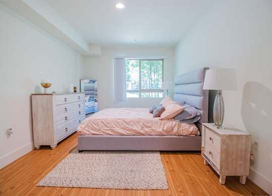 A bedroom with a bed, nightstand, and dresser at Woodley Sara Apartment, Van Nuys