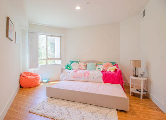 A bedroom with a large bed and a pink blanket at Woodley Sara Apartment, Van Nuys, CA, 91406