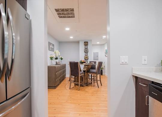 A kitchen with a table and chairs in the middle of the room at Woodley Sara Apartment, Van Nuys, 91406